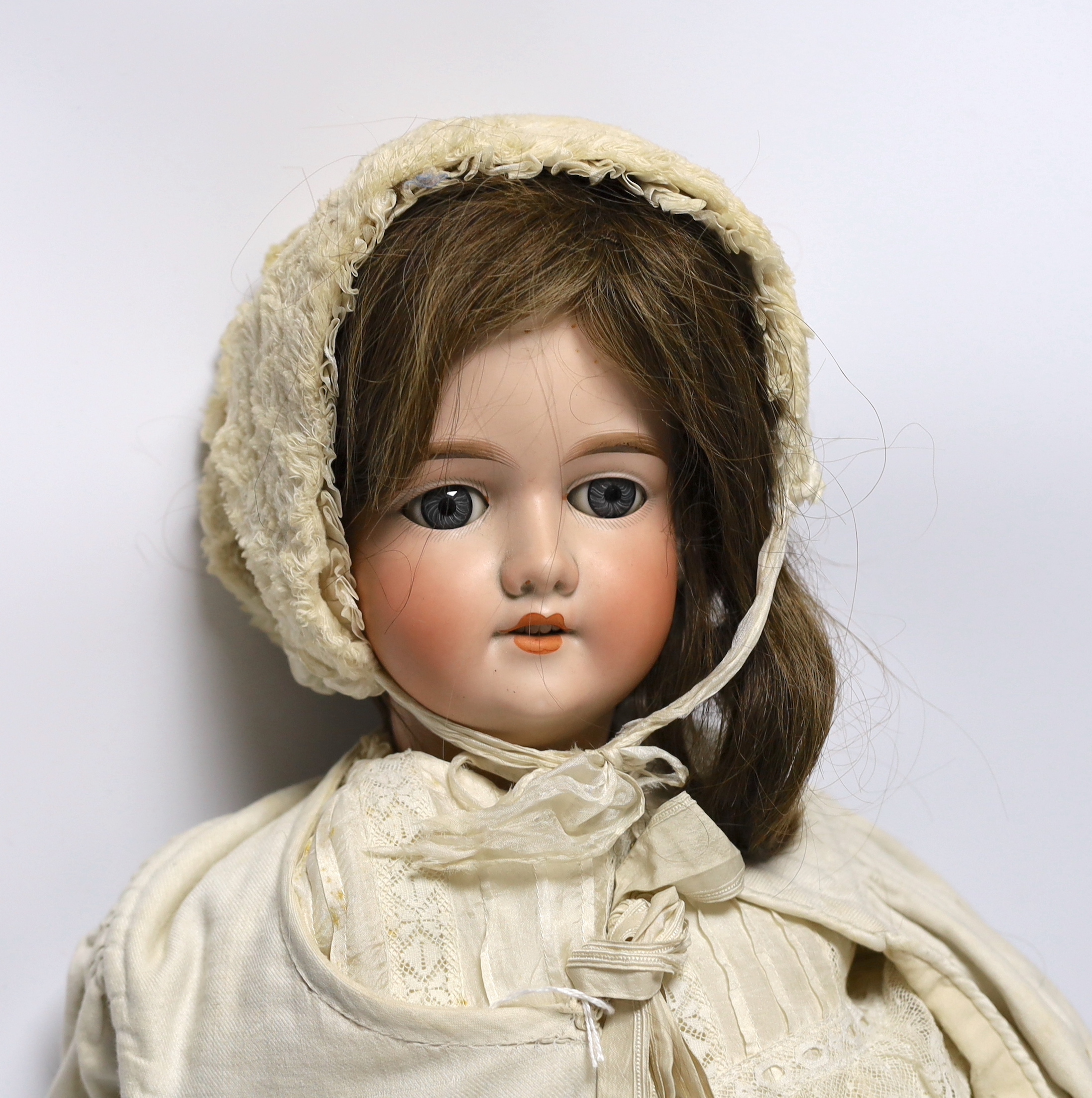 A porcelain doll, marked to the back of the neck ‘390 A12M’, 75cm